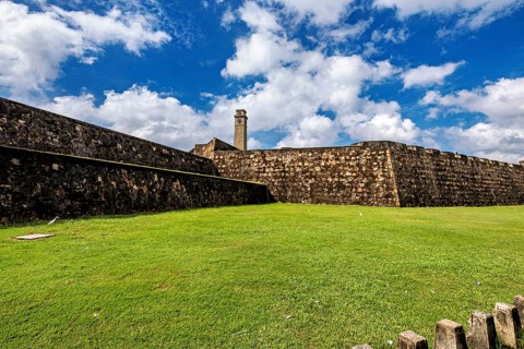 Stone wall of a fortress against a blue, cloudy sky, The fortress of Galle in Sri Lanka