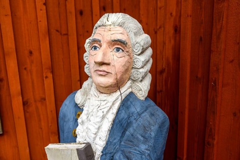 Wooden statue of botanist and founder of the binary nomenclature Carl von Linné with white hair and