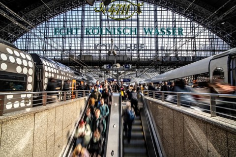 Cologne Central Station, escalators to and from the platform, passengers waiting for the train,