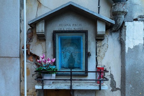 The veneration of the Virgin in a niche of a house wall, Venice, Veneto, Italy