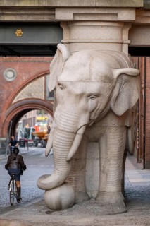 Bicyclist, monumental stone elephant, Elephant Gate or Elephant Portal or Elefantporten, by