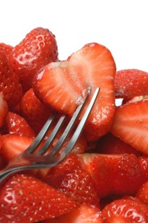 Halved strawberries in a bowl, Fragaria