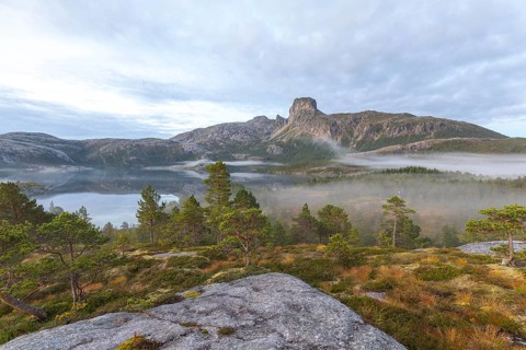 Magical morning fog on Steigtindvatnet in front of the majestic Steigtinden in Norway near Bodø