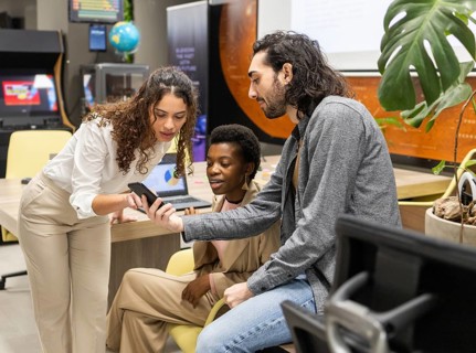 A diverse group of professionals collaborates in a modern office, discussing information displayed