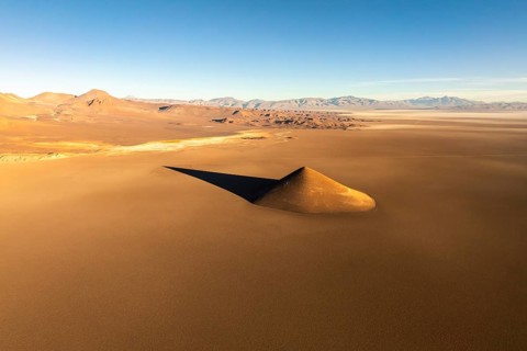 From above, the Cono de Arita rises dramatically from the flat puna landscape in Salta, Argentina.