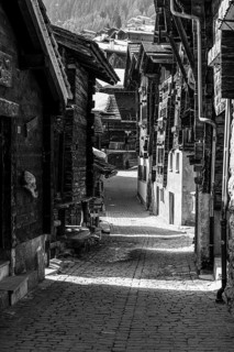 Old farmhouses in the Rue du Village, black and white photo, historic town center, Grimentz, Val