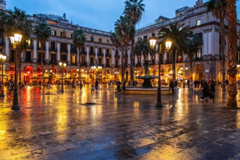 Nightlife at Plaça Reial, lanterns by Gaudi in the historic centre of Barcelona, Spain