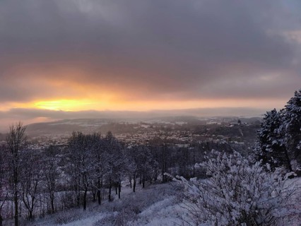 Snowy landscape at sunset with view of Rosenberg Kronach Fortress, Frankenwald nature park Park