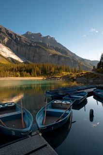 Scenic view of blue boats peacefully docked on the calm waters of Oachinensee, Switzerland,