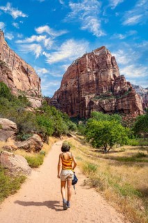 A young woman starting the trekking climb of the Angels Landing Trail in Zion National Park, Utah.