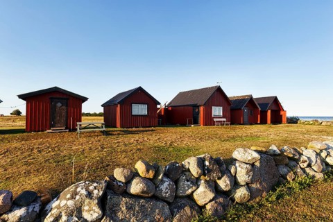 Traditional red fishing huts, Sjöbodar, holiday homes on the Baltic Sea coast, coastal landscape,