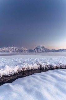 Shortly after sunset, twilight at Lake Hopfensee in the Allgäu in Bavaria in a winter landscape,