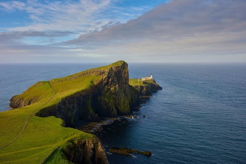 Wide landscape with a lighthouse on a green cliff by the sea, Neist Point Lighthouse, Waterstein,