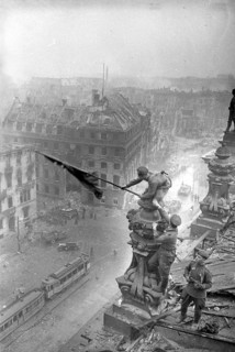 At the Berlin Reichstag, May 2, 1945, three Soviet soldiers fly the flag of the Soviet Union. The