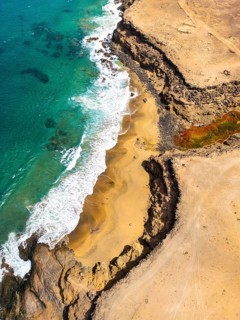 Top view of Tindaya Beach on Fuerteventura Island, featuring untouched sandy shores and rocky