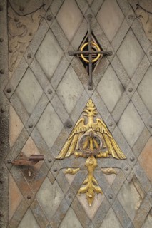 Front door with metal fittings and golden eagle figure relief, door knock ring, door knocker,