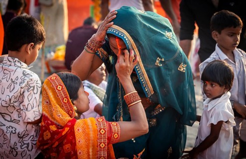 Hindu devotees gather on the banks of the Brahmaputra River to offer prayers to the Sun God on the