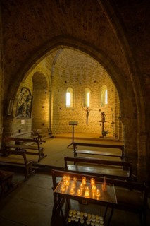 Side chapel with burning candles in the Abbey of Gellone, also Saint-Guilhem-le-Désert Monastery,