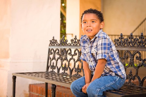 Handsome African American and Mexican Boy Sitting on Park Bench