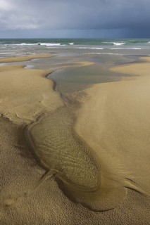 Tide pools on sand beach at low tide at Cap Blanc Nez, Pas-de-Calais, France