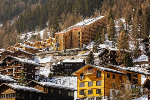 Snow-covered hotels and chalets built into the hillside, Grimentz, Val d'Anniviers, Valais Alps,