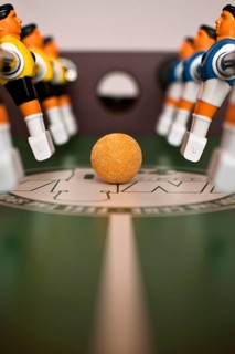 Foosball table close-up of the ball and players in Poland