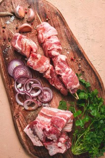 Raw pork meat, on wooden sticks, pickled kebab, with spices, top view, no people