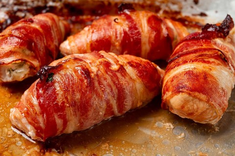 Baked chicken breast, wrapped in bacon, on a baking tray. in the home kitchen.close-up