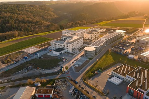 Modern office buildings with solar systems in a hilly area at sunset, new hospital at the Verbund