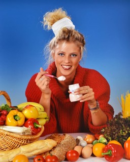Young blonde woman at breakfast, 25, 3years, eating a yoghurt Studio shot, Lower Saxony, Federal