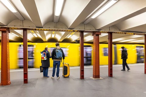 Alexanderplatz underground station with subway. People on the platform. Berlin, Germany