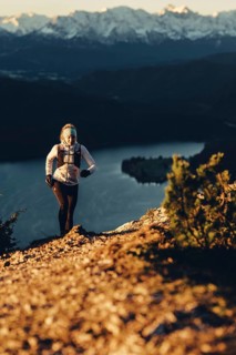 Trail running in autumn on the Jochberg on Lake Walchensee against the wonderful backdrop of the