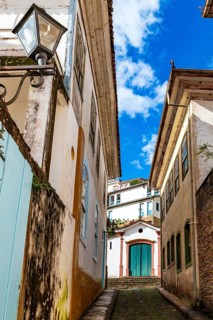 Alley with a church in the background in the city of Ouro Preto, Ouro Preto, Minas Gerais, Brazil
