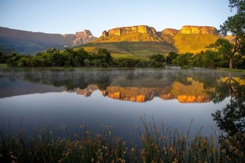 Sunrise, amphitheatre with reflection in the lake, Royal Natal National Park, Drakensberg Mountains