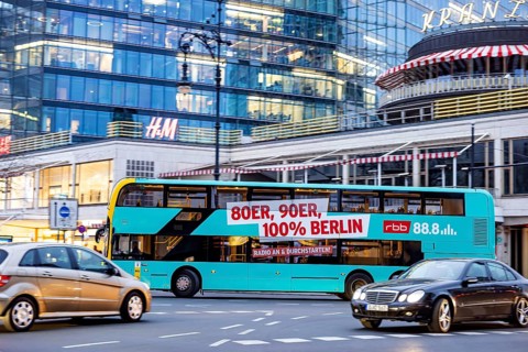 Double-decker bus on Kurfürstendamm. City view of Berlin. BVG public bus with advertising for music