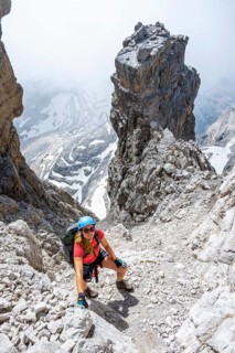 Female hiker climbs the Cima falconer mountain peak, Brenta Mountains, Brenta, Brenta-Adamello