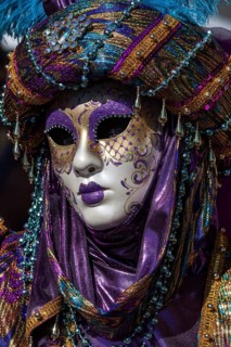 Venetian carnival mask and costumes at the Venetian fair on the historic market square,