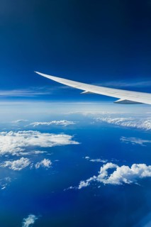 View from the aircraft window during a flight over India with the airline Etihad. Blue sky and