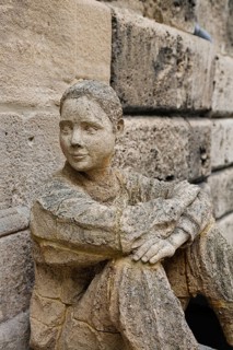 Sculpture in front of the old school building, art in public space, stone figure, sculpture by the