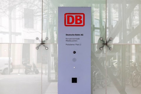 City view of Berlin. Deutsche Bahn AG logo in the entrance area of the headquarters. Railway tower