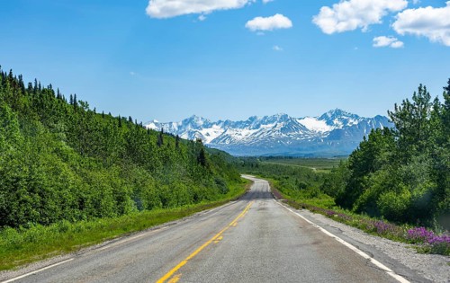 Road through taiga and mountainous landscape, picturesque landscape on Richardson Highway, Alaska,