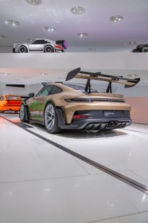 Modern GT3 sports car with large rear wing in an exhibition hall, Porsche Museum, Stuttgart,