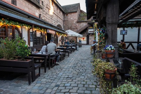 Outdoor dining at the Franconian wine tavern im Handwerkerhof in the old town of Nuremberg, Middle