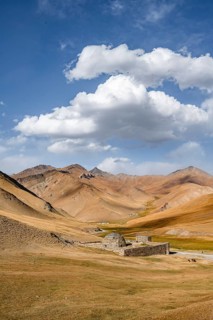 Historic caravanserai Tash Rabat from the 15th century, with yellow hills, Atbashy district in the
