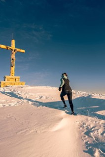 Summit bliss in the snow-covered winter landscape in the Tannheimer Tal in the Alps on the