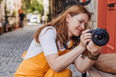 Woman traveler joyfully explores the historic streets of an old town in Turkey, capturing memories