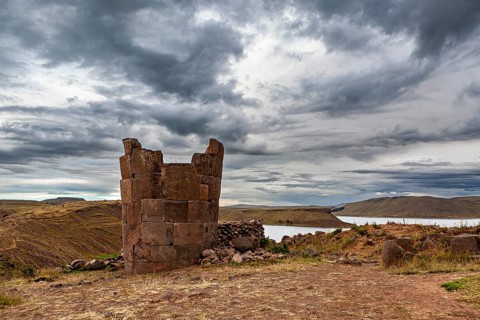 Ruin of an old stone tower against a cloudy sky, The Chullpas of Sillustani near Puno in Peru
