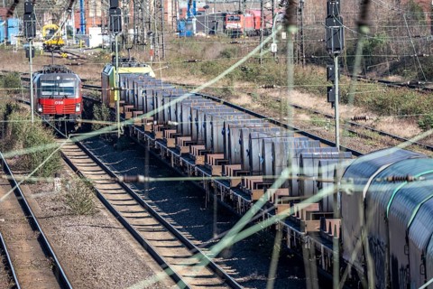 Freight train on the line in front of the Oberhausen-Osterfeld marshalling yard, loaded with steel