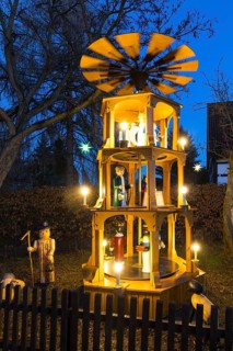 Christmas pyramid with wooden figures in the village of Unkersdorf in the evening, Dresden, Saxony,