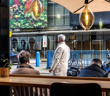 View through the window of a café of passers-by on Friedrichstraße in Mitte, Berlin, Germany